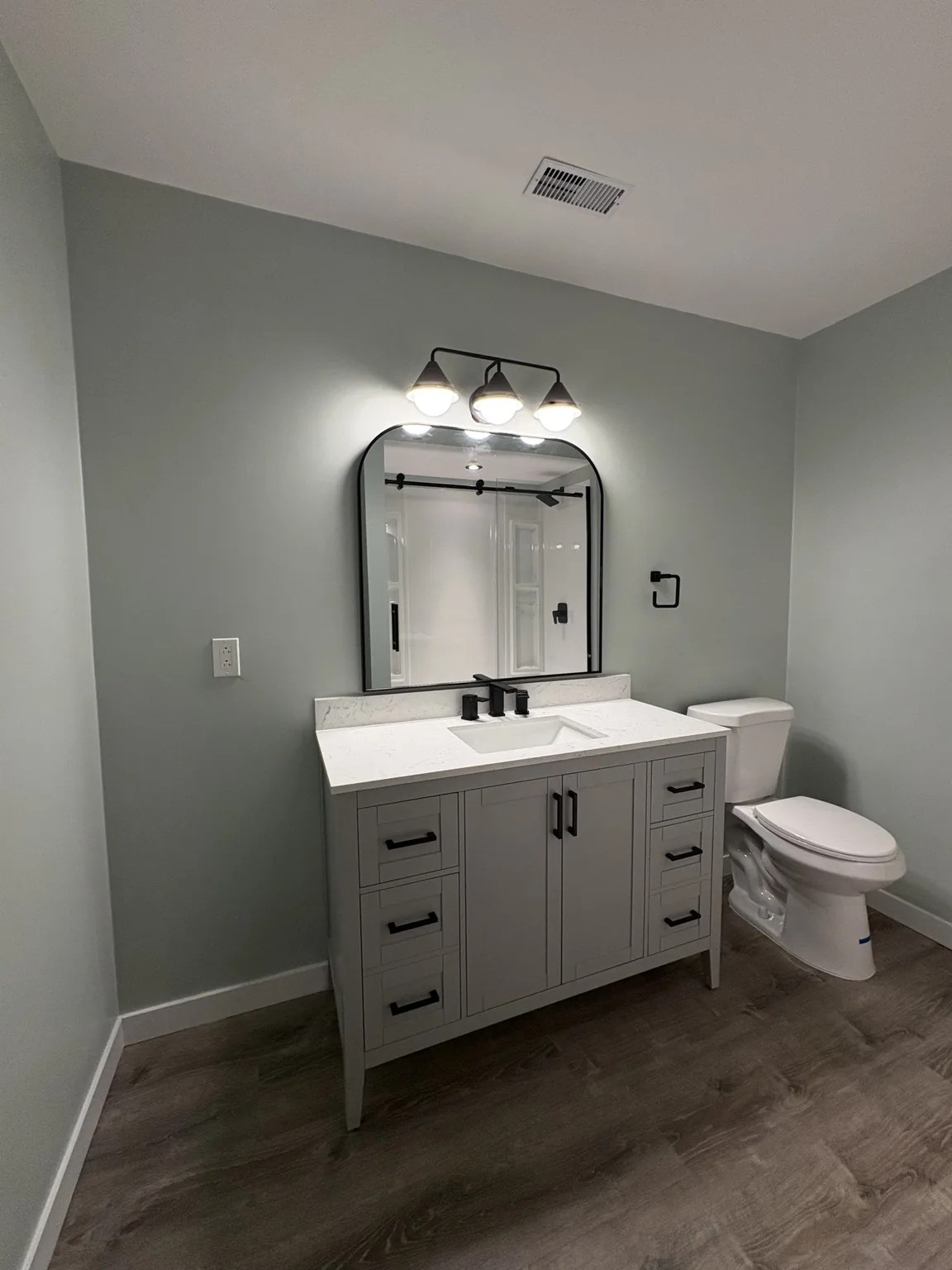 Finished bathroom vanity, mirror and fixtures