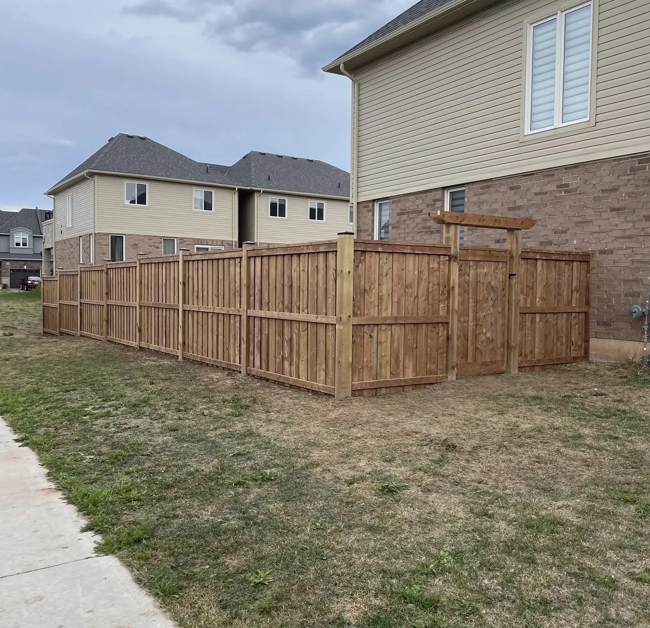 Finished wood privacy fence installation